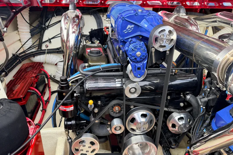 Slide: The Image of Engine of a 2011 Sunsation F4 boat, featuring a blue supercharger and polished components. - 44