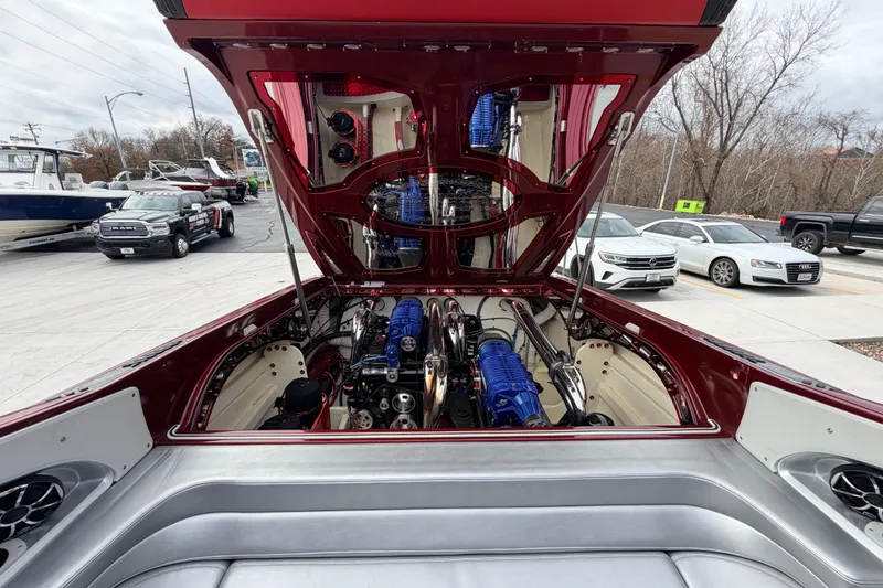 Slide: The Image of 2011 Sunsation F4 boat engine compartment with open hatch, showcasing powerful blue engines. - 47