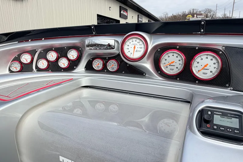 Slide: The Image of Dashboard of a 2011 Sunsation F4 boat with multiple gauges and controls. - 52