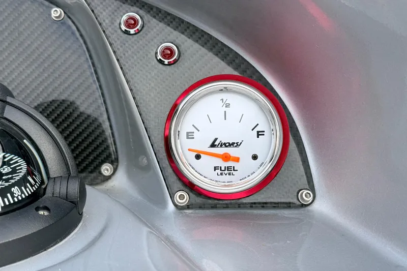Slide: The Image of Fuel gauge and compass on 2011 Sunsation F4 dashboard, featuring carbon fiber accents. - 54