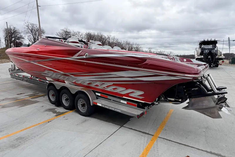 Slide: The Image of 2011 Sunsation F4 powerboat in vibrant red on a trailer, parked outdoors. - 6