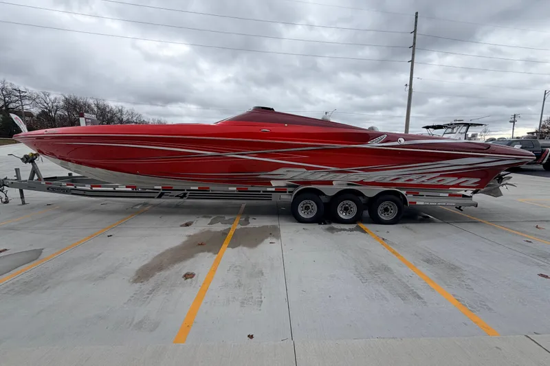 Slide: The Image of 2011 Sunsation F4 powerboat in vibrant red on a trailer, parked in a lot. - 7