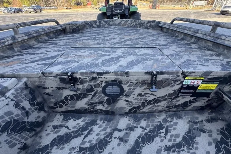Slide: The Image of Camouflage-patterned interior of a 2025 Havoc 1860 boat, featuring storage compartments and safety labels. - 15