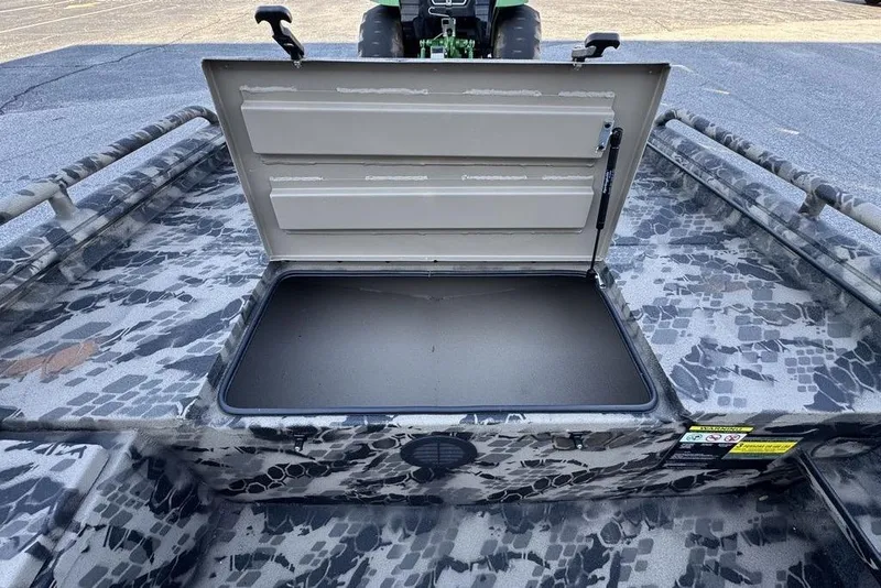 Slide: The Image of Open storage compartment on 2025 Havoc 1860 boat with camouflage pattern. - 18