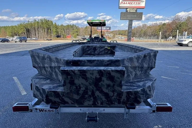 Slide: The Image of 2025 Havoc 1860 boat with camouflage design on a trailer in a parking lot. - 3