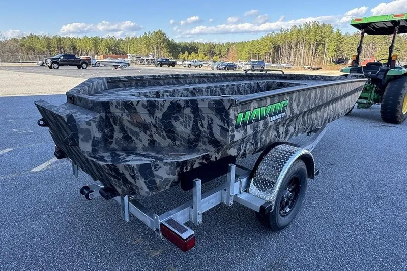 Slide: The Image of 2025 Havoc 1860 boat with camouflage design on a trailer in a parking lot. - 5