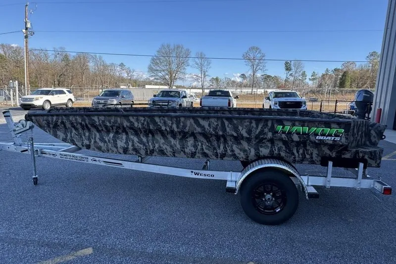 Slide: The Image of 2025 Havoc 1860 boat with camouflage design on a trailer in a parking lot. - 6