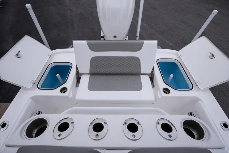 Slide: The Image of 2026 Caymas 24 HB boat interior with seating, storage compartments, and rod holders. - 12