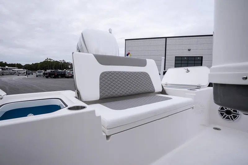 Slide: The Image of 2026 Caymas 24 HB boat interior with cushioned seating and storage compartments. - 13