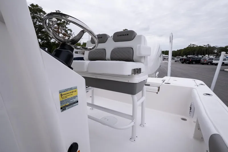Slide: The Image of 2026 Caymas 24 HB boat interior with steering wheel and seating, showcasing modern design. - 14