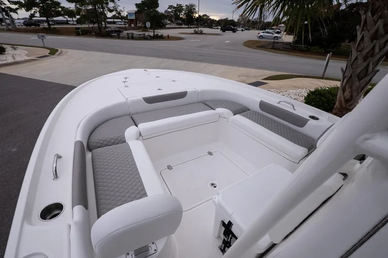 Slide: The Image of 2026 Caymas 24 HB boat interior with cushioned seating and modern design. - 16