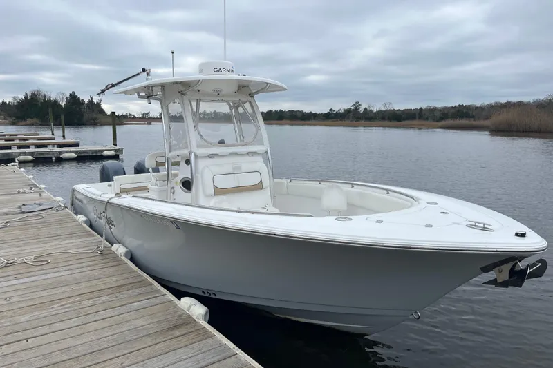 Slide: The Image of 2014 Sportsman Heritage 251 Center Console boat docked on a calm lake. - 9