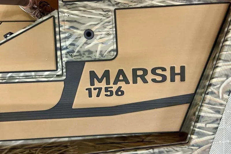 Slide: The Image of 2026 Tracker Grizzly 1756 T Marsh boat with camouflage design and bold lettering. - 11