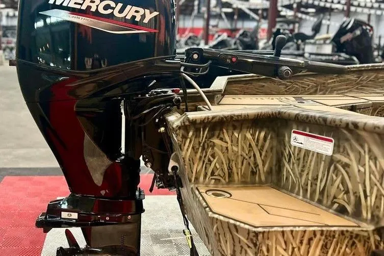 Slide: The Image of 2026 Tracker Grizzly 1756 T Marsh boat with Mercury outboard motor, camo design. - 3