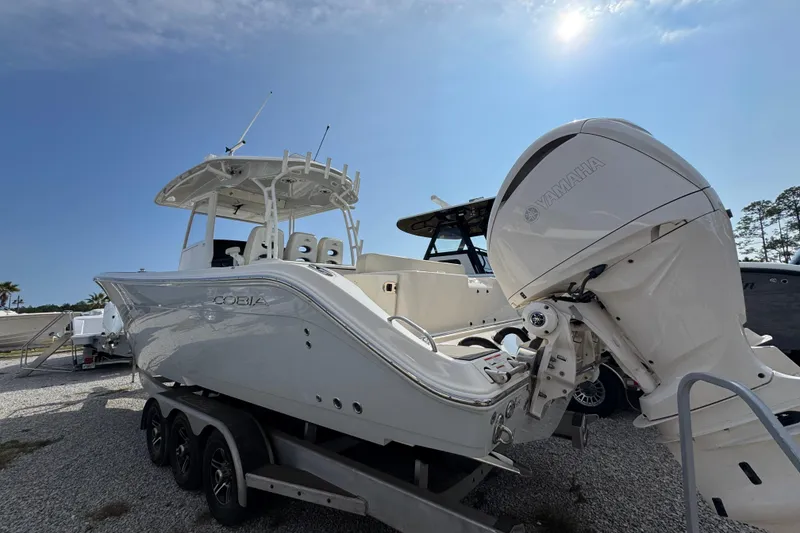 Slide: The Image of 2022 Cobia 350 Center Console boat with Yamaha engine on trailer under clear sky. - 11