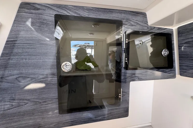 Slide: The Image of 2022 Cobia 350 Center Console interior with sleek, modern cabinetry and reflective surfaces. - 21