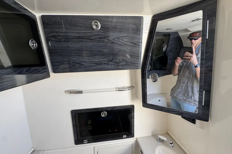 Slide: The Image of 2022 Cobia 350 Center Console interior with wood accents and mirror reflection. - 22