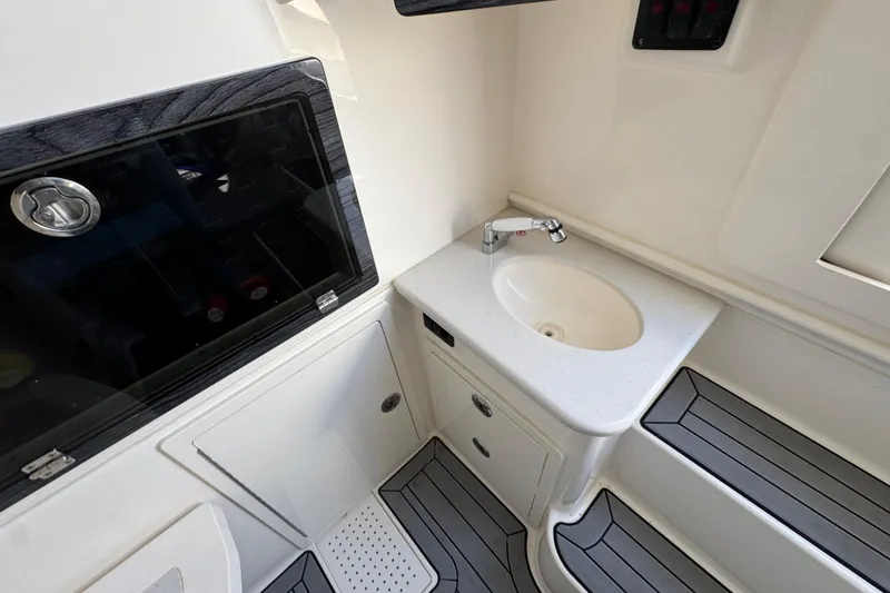 Slide: The Image of 2022 Cobia 350 Center Console boat interior with sink and storage compartments. - 23