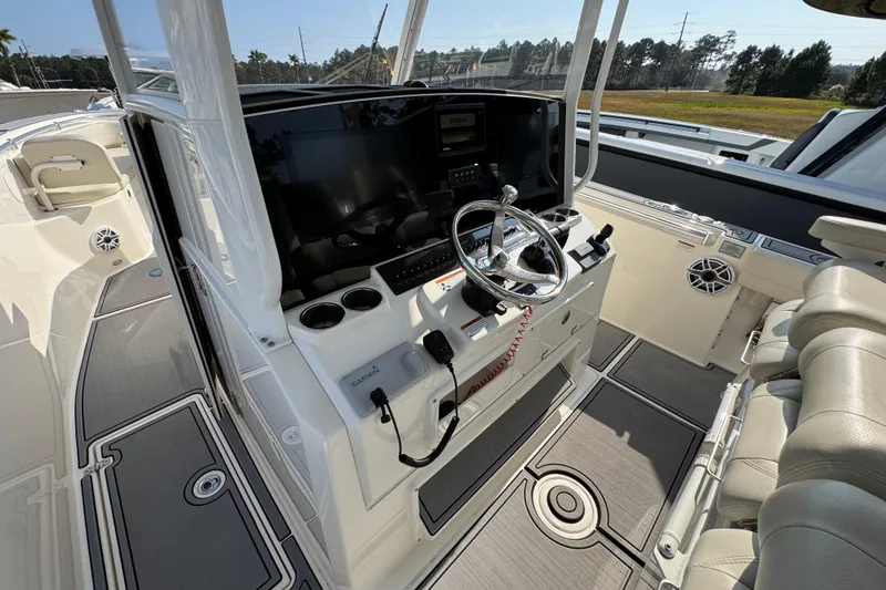 Slide: The Image of 2022 Cobia 350 Center Console boat interior with steering wheel and navigation equipment. - 29