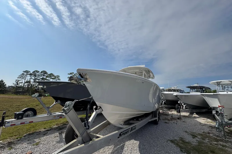 Slide: The Image of 2022 Cobia 350 Center Console boat on trailer under clear sky. - 3
