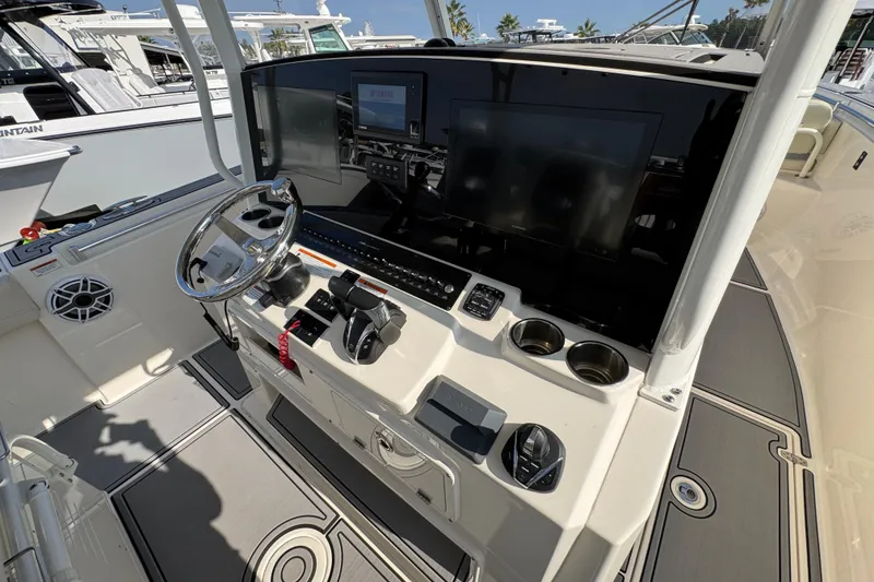 Slide: The Image of 2022 Cobia 350 Center Console boat dashboard with steering wheel and controls. - 31