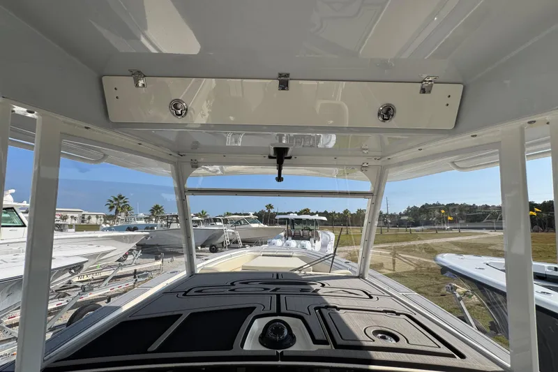 Slide: The Image of 2022 Cobia 350 Center Console boat interior view with clear skies and surrounding boats. - 32