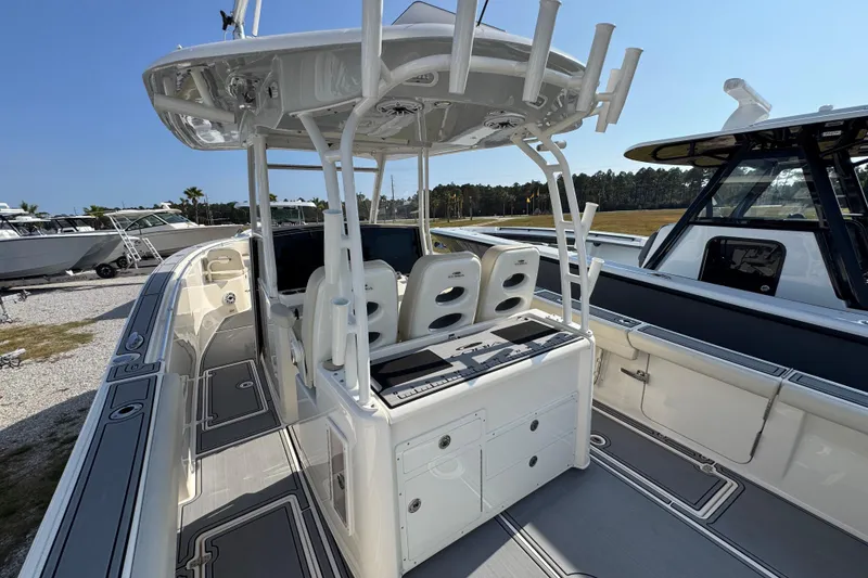 Slide: The Image of 2022 Cobia 350 Center Console boat interior with seating and rod holders. - 35