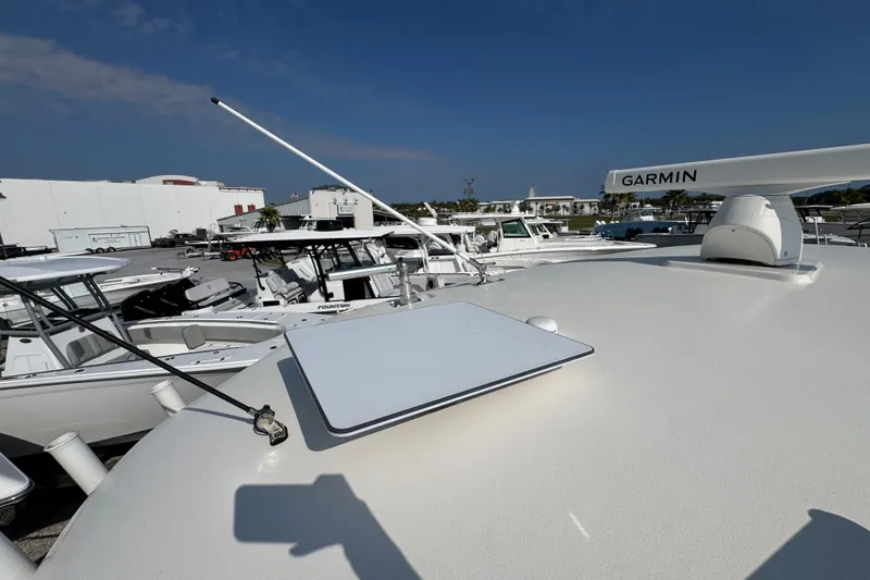 Slide: The Image of 2022 Cobia 350 Center Console boat with Garmin equipment, docked under clear blue sky. - 38