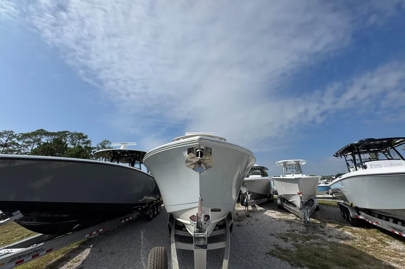 Slide: The Image of 2022 Cobia 350 Center Console boats on trailers under a clear sky. - 4
