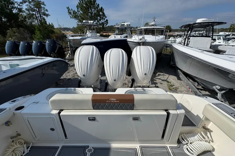 Slide: The Image of 2022 Cobia 350 Center Console with triple outboard engines in a boatyard. - 40