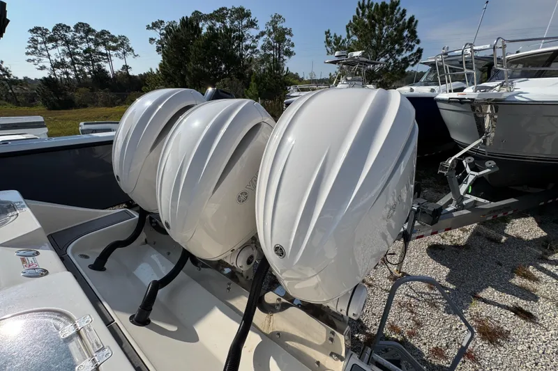 Slide: The Image of 2022 Cobia 350 Center Console with triple Yamaha outboard engines in a marina setting. - 42