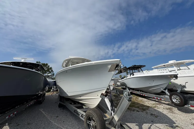 Slide: The Image of 2022 Cobia 350 Center Console boat on trailer under blue sky. - 5
