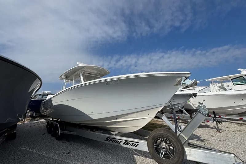 Slide: The Image of 2022 Cobia 350 Center Console boat on trailer under blue sky. - 6