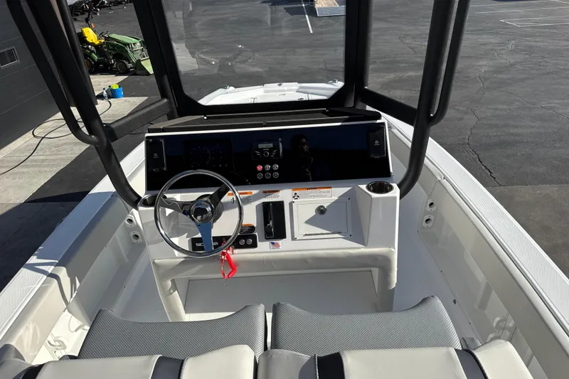 Slide: The Image of 2026 Scarab 235 Open SE boat cockpit with steering wheel and control panel. - 15