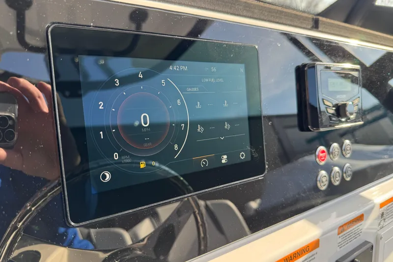 Slide: The Image of Dashboard of 2026 Scarab 235 Open SE boat with digital display and controls. - 16