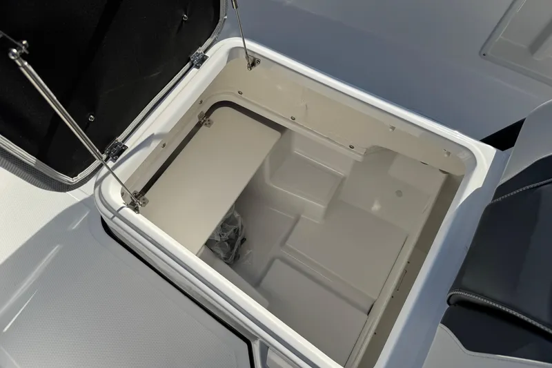 Slide: The Image of Open storage compartment in 2026 Scarab 235 Open SE boat. - 21
