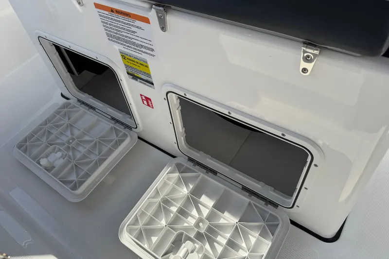 Slide: The Image of 2026 Scarab 235 Open SE boat storage compartments with open lids and safety warnings. - 22