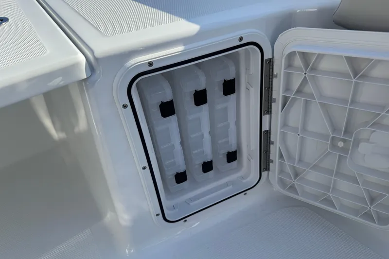 Slide: The Image of Open storage compartment on 2026 Scarab 235 Open SE boat, showcasing interior design. - 25