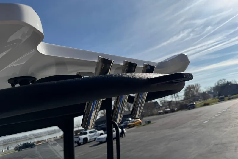 Slide: The Image of Close-up of 2026 Scarab 235 Open SE boat's rod holders under a clear sky. - 26