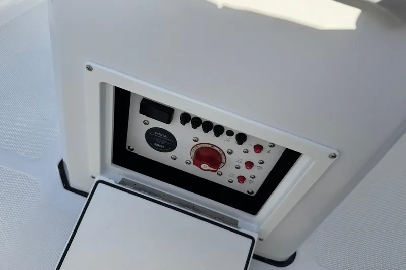 Slide: The Image of Control panel of 2026 Scarab 235 Open SE boat, featuring switches and dials. - 27