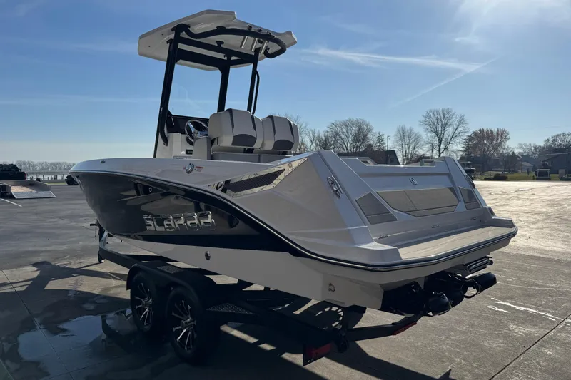 Slide: The Image of 2026 Scarab 235 Open SE boat on trailer, parked outdoors under clear sky. - 3
