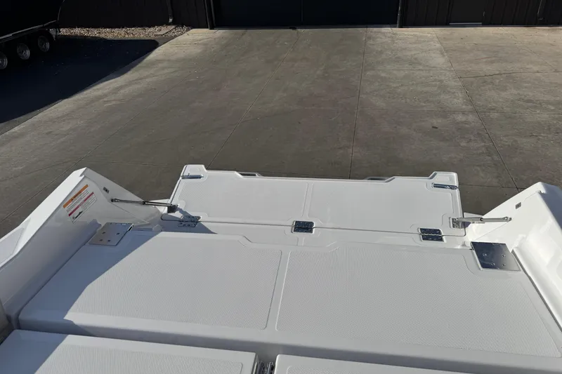 Slide: The Image of 2026 Scarab 235 Open SE boat deck, featuring sleek white design and sturdy hinges. - 33