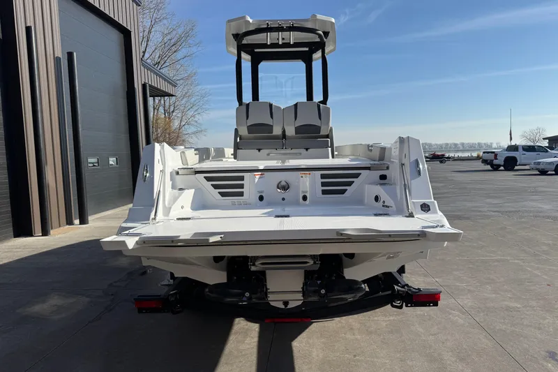 Slide: The Image of 2026 Scarab 235 Open SE boat, rear view, parked outdoors on a sunny day. - 6