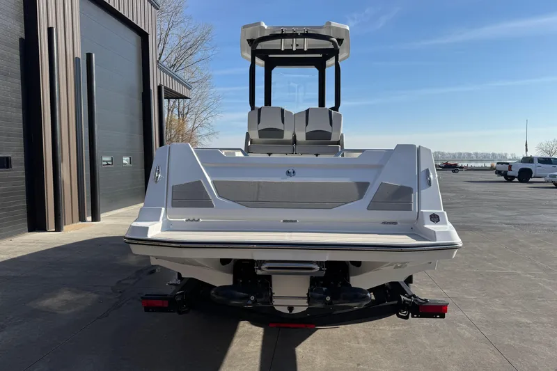 Slide: The Image of 2026 Scarab 235 Open SE boat, rear view, parked outdoors near a building. - 7