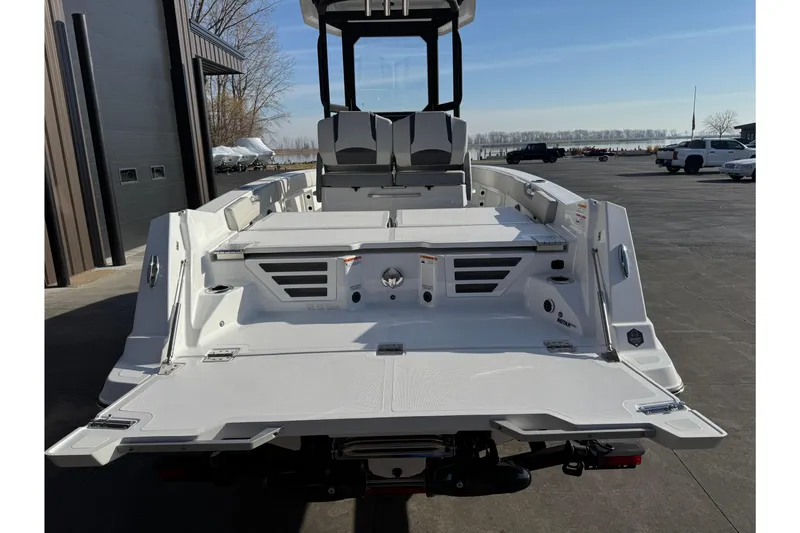 Slide: The Image of 2026 Scarab 235 Open SE boat, rear view, docked outdoors on a sunny day. - 8
