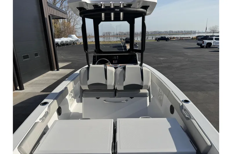 Slide: The Image of 2026 Scarab 235 Open SE boat interior with seating and console, docked outdoors. - 9