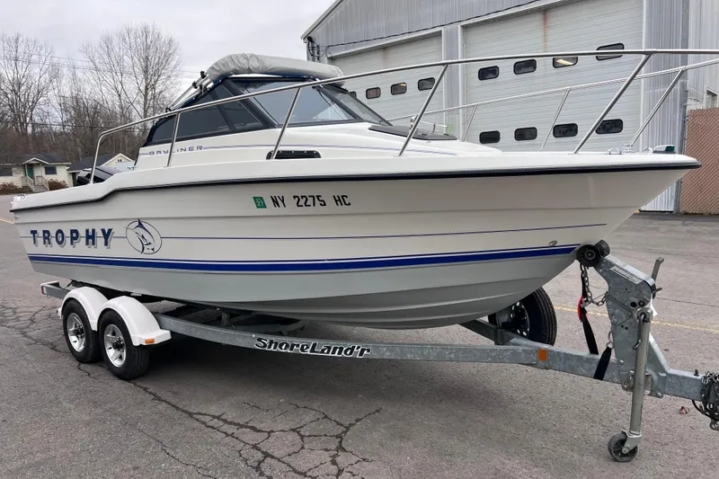 Slide: The Image of 1993 Bayliner Trophy Walkaround boat on ShoreLand'r trailer, parked outside a warehouse. - 11