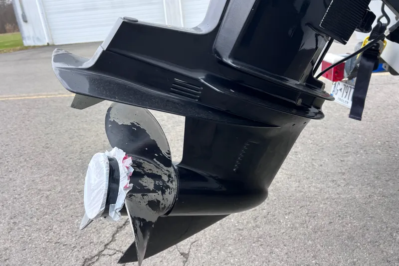 Slide: The Image of Close-up of a 1993 Bayliner Trophy Walkaround boat propeller on pavement. - 13