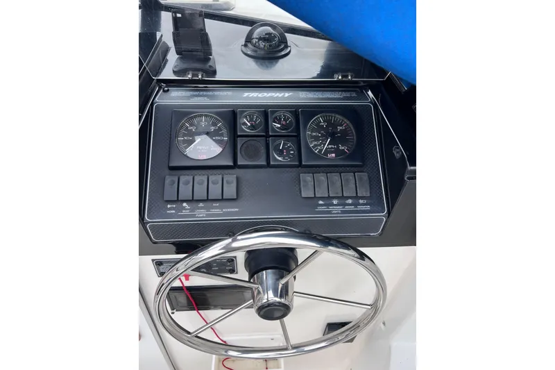 Slide: The Image of 1993 Bayliner Trophy Walkaround dashboard with steering wheel and instrument panel. - 16