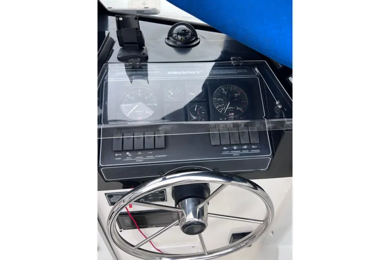 Slide: The Image of 1993 Bayliner Trophy Walkaround dashboard with steering wheel and instrument panel. - 17